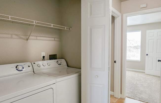 laundry with travertine in Briarwood floor plan