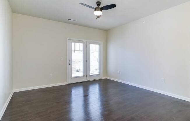 Ashland Farms Spacious Living Room with Wood Flooring, and Window Door to Patio
