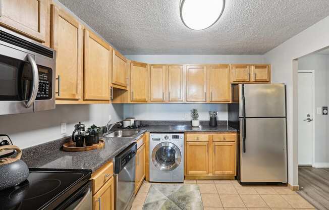 a kitchen with stainless steel appliances and wooden cabinets