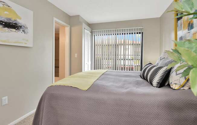 a bedroom with a large bed and a large window