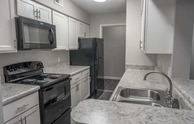 an empty kitchen with granite counter tops and stainless steel appliances