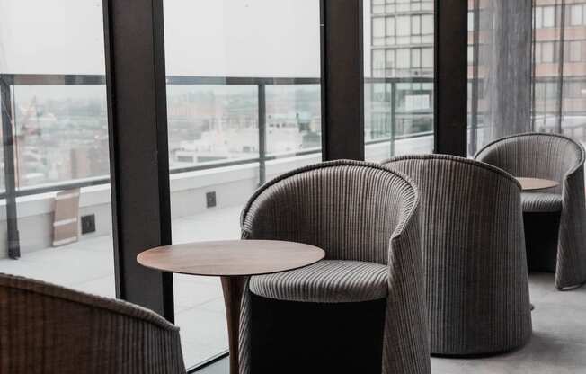 a seating area with chairs and a table in a window at The Lively, Jersey City, NJ