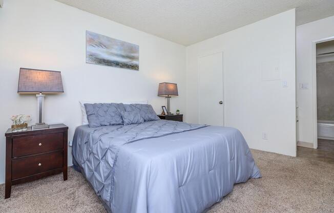 a bedroom with a bed and desk in a room