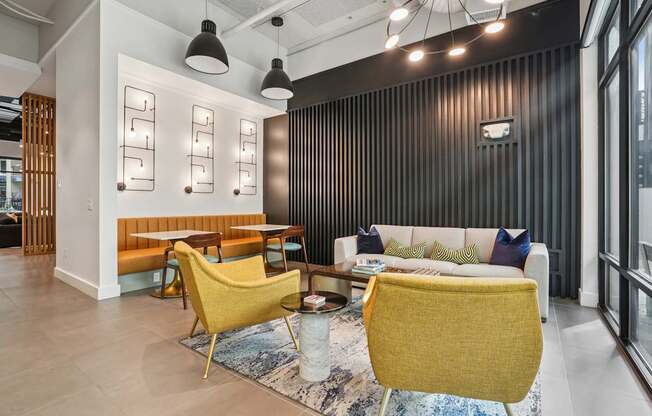 A modern living room with a yellow chair and a white sofa.