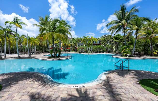 a swimming pool at a resort with palm trees