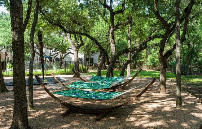 Shaded hammocks tucked beneath mature oaks—your go-to spot for peaceful afternoons at Alister Sunset Valley.
