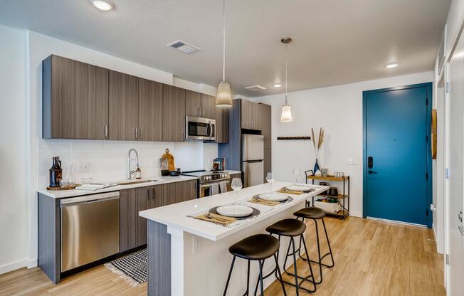 a kitchen with a long island with four stools