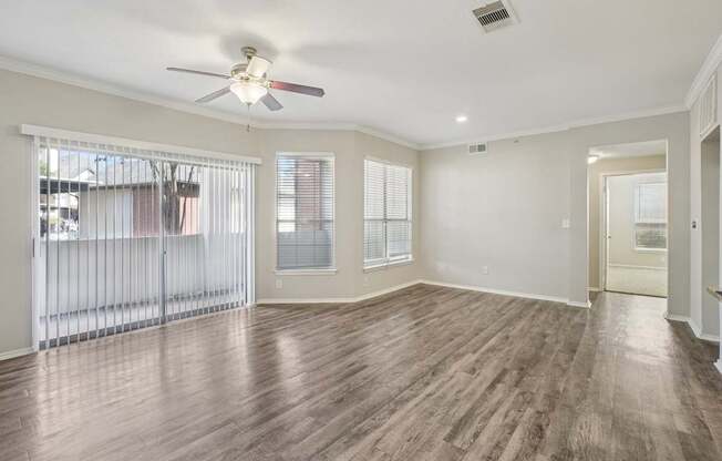 A room with wooden floors and a ceiling fan.