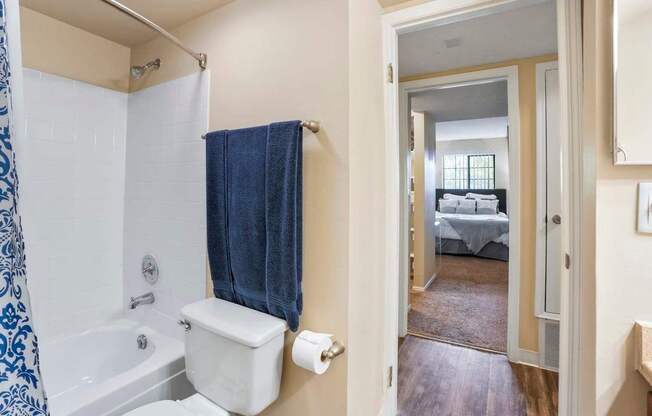 A bathroom with a blue and white shower curtain.