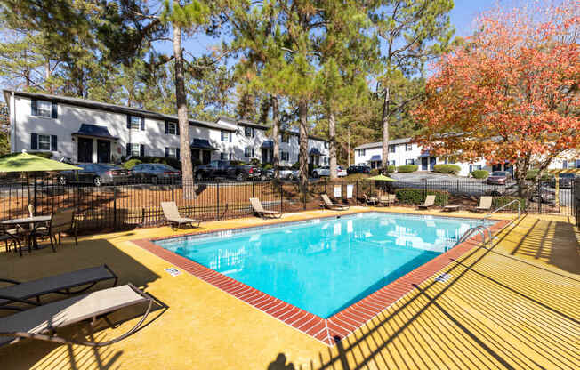 a resort style pool with chairs around it