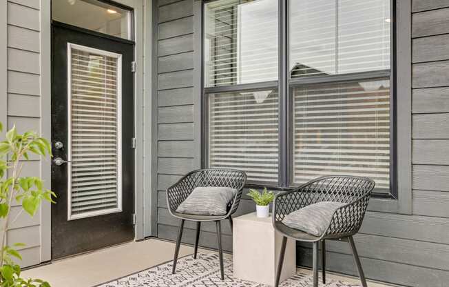 a patio with two chairs and a small table at Prism at Diamond Ridge, Moon Township, PA, 15108