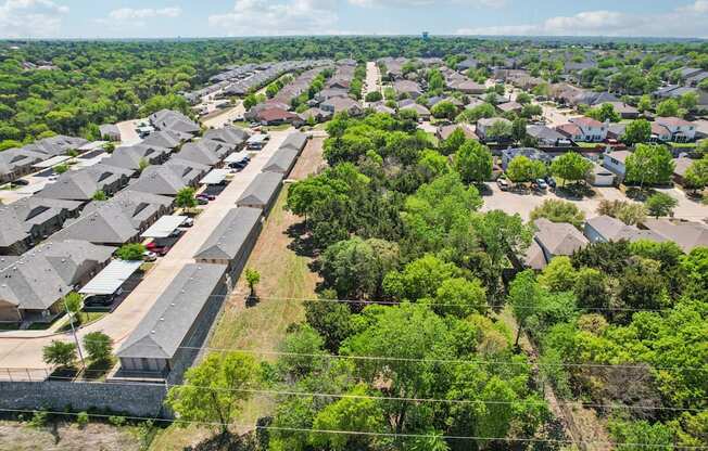 A bird's eye view of a residential area with houses and trees.