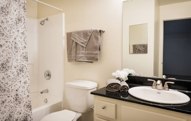 a bathroom with a toilet sink and shower