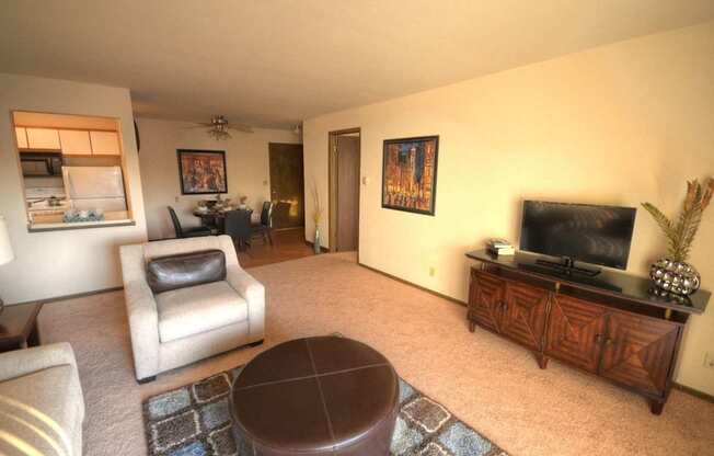 a living room with a couch and a chair and a television