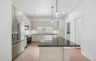 A modern kitchen with a large island in the center.