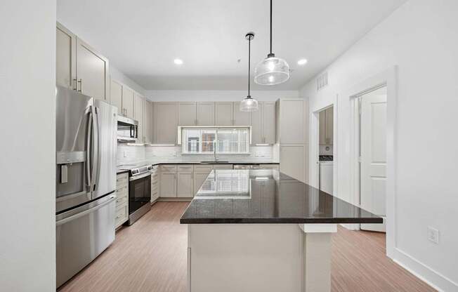 A modern kitchen with a large island in the center.
