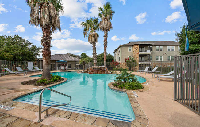our apartments have a large swimming pool with palm trees
