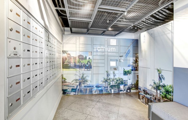 a locker room with white lockers and a mural on the wall