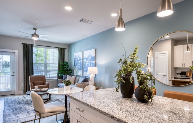 A kitchen with a table and chairs and a fan.