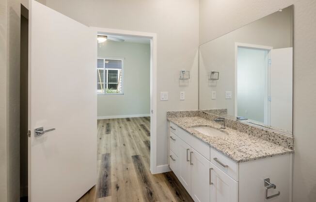 a bathroom with a large mirror and a large sink