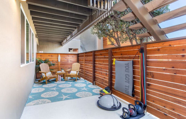 a patio with a wooden fence and a pair of shoes on the floor at Element LLC, Sunnyvale, CA