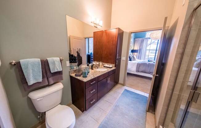 a bathroom with a toilet and a sink and a shower