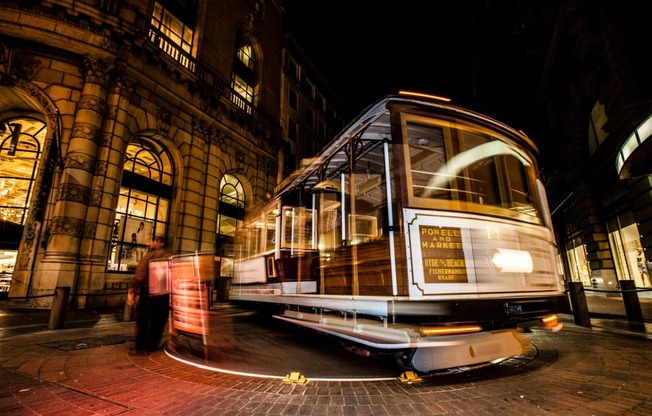 a trolley car on the street at night at L Seven, CA 94103