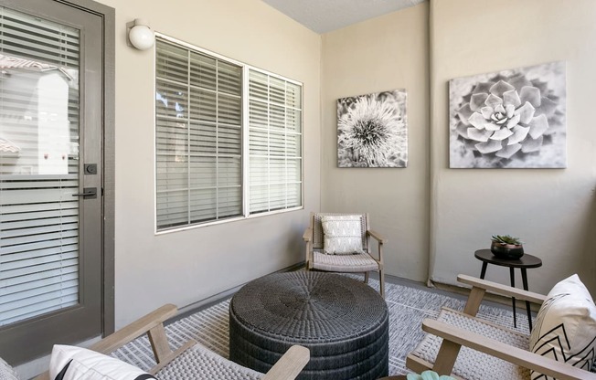 a living room with a chair and a table and a door