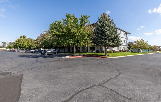 a parking lot in front of a building with trees  at Shoreline Village, Richland, Washington