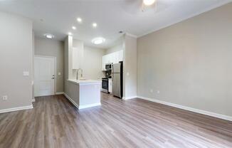 A kitchen area with a white countertop and wooden flooring. at Vue at Embry Hills, Atlanta, GA, 30042
