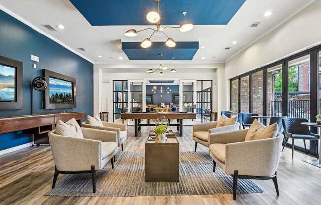 A living room with a blue wall and a wooden floor.