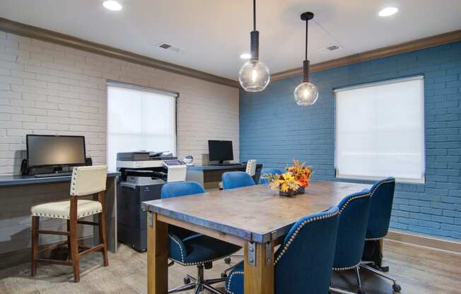 a conference room with blue chairs and a wooden table