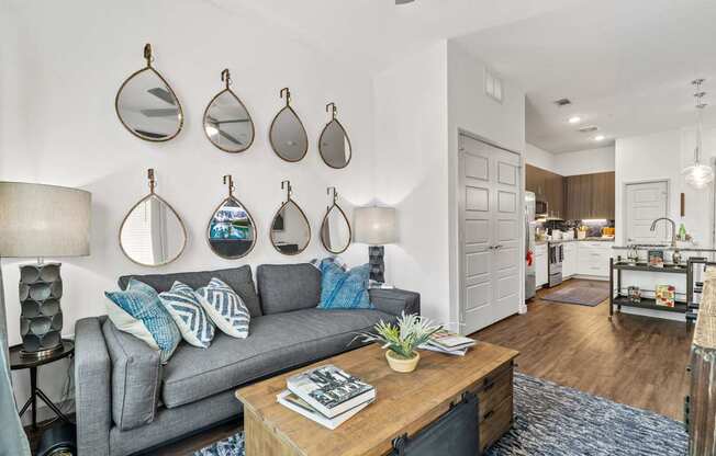 A living room with a grey couch and a coffee table.
