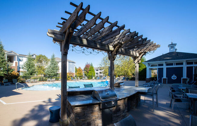 a patio with a bar and a swimming pool