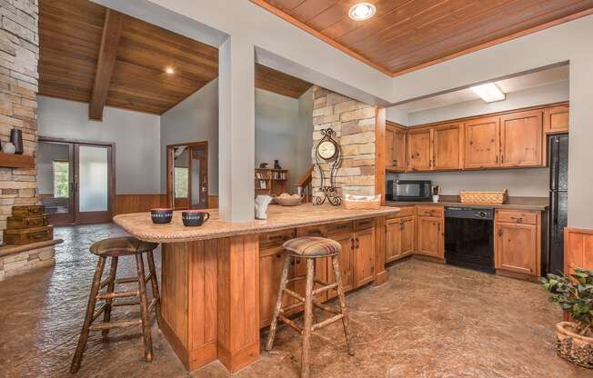 a large kitchen with a large island with bar stools at Lodge of Overland Park Apartments, Kansas