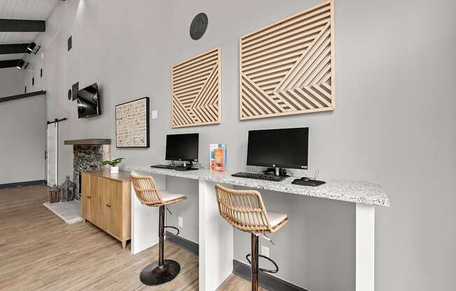A room with a desk and two chairs.