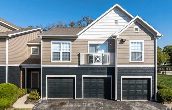 A two-story house with a balcony on the second floor.