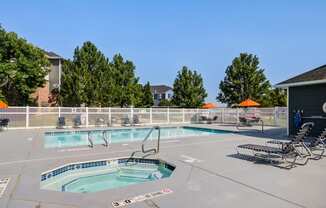 our resort style swimming pool is next to our building with two chaise lounge chairs