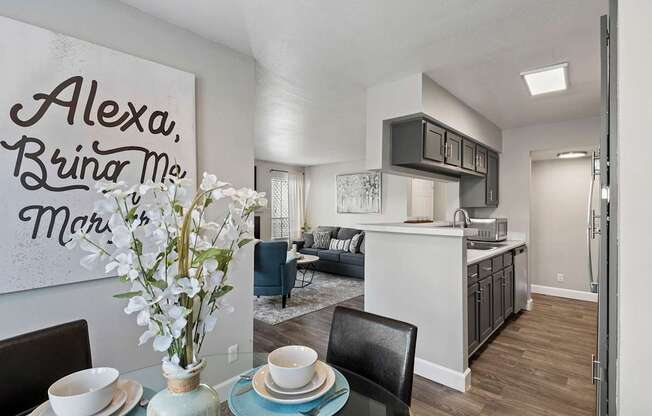 a living room and kitchen with a dining room table and chairs