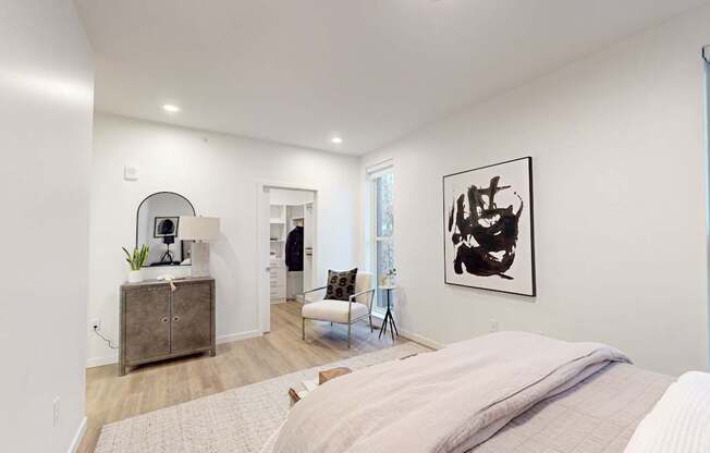 A bedroom with a large bed and a painting on the wall at One West Drive Apartments, Excelsior, Minnesota