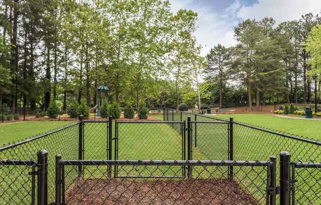 A black fence surrounds a baseball diamond.