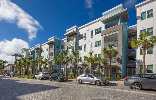 Cars parked along roadside in front of Residences at The Green Apartment homes