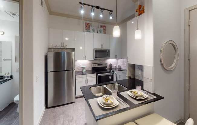 a kitchen with white cabinetry and stainless steel appliances