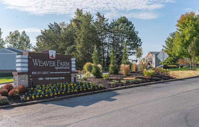 the welcome sign at weaver farm apartments