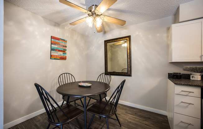 Dining area with a table and four chairs at Windmill Apartments, Colorado, 80916