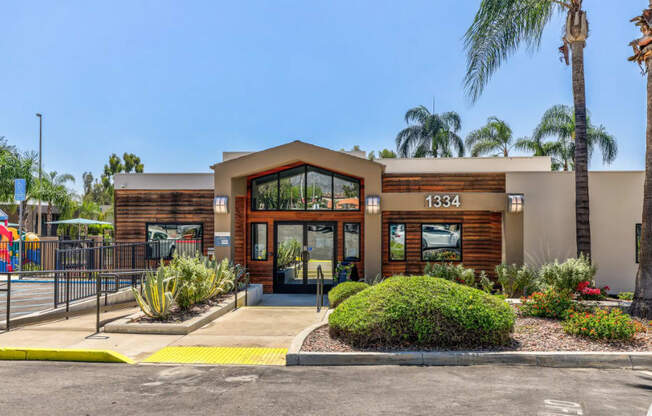 the front of a building with palm trees at Aspire Upland Apartments, Upland, CA, 91786