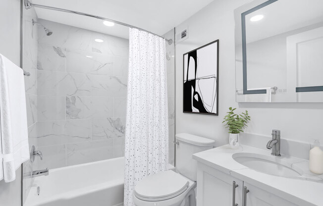 a white bathroom with a shower and a sink