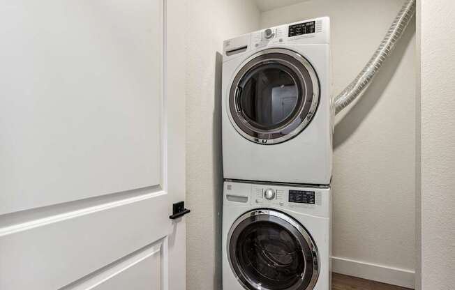 A white washing machine and dryer in a small laundry room.