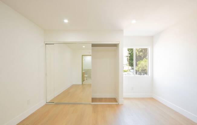 a living room with white walls and a sliding glass door