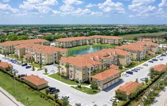 an aerial view of an apartment complex next to a lake